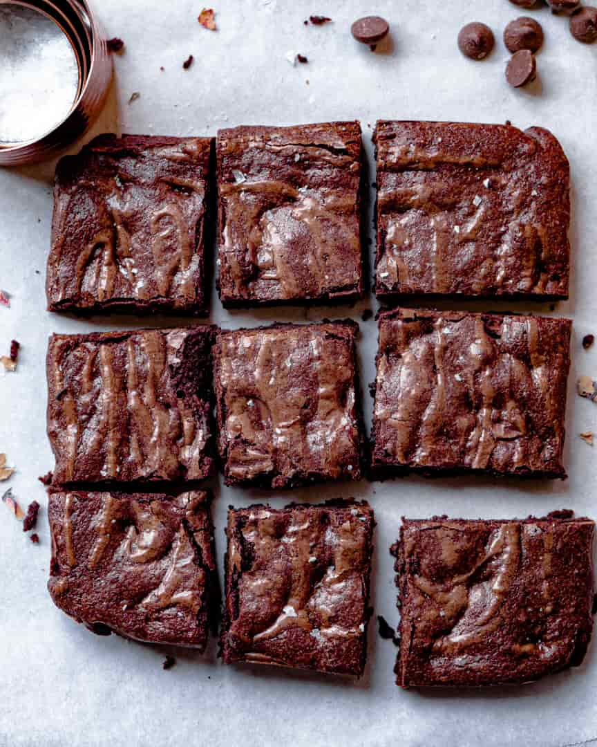 Brownies cut into squares laying next to each other.