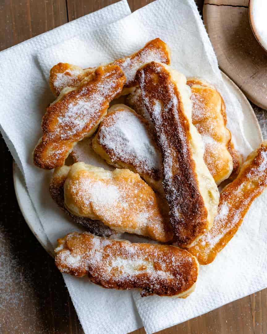 Fried pizza dough strips with white sugar sprinkled on top
