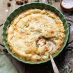 Gluten-Free chicken pot pie with a scoop missing and a spoon ready to grab the next portion