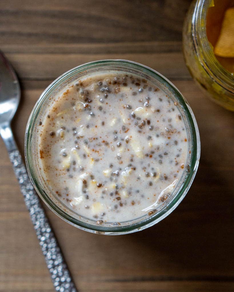 Overnight Oats in a glass jar with spoon next to it.