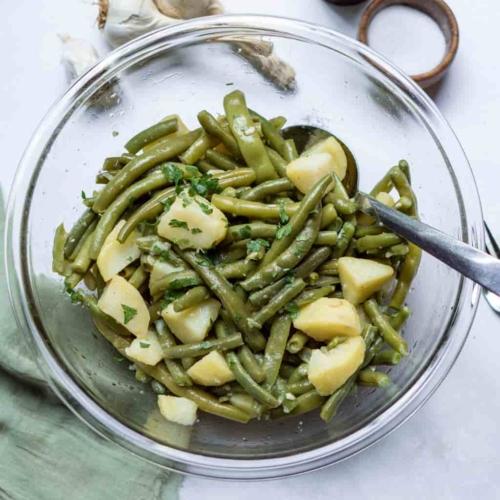 Green Beans and potatoes in a bowl with a spoon