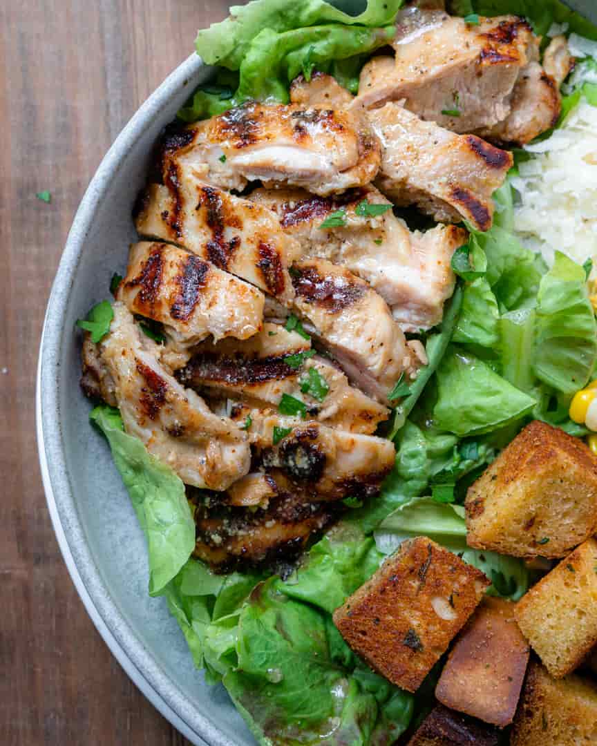 Grilled chicken sliced on a bed of lettuce