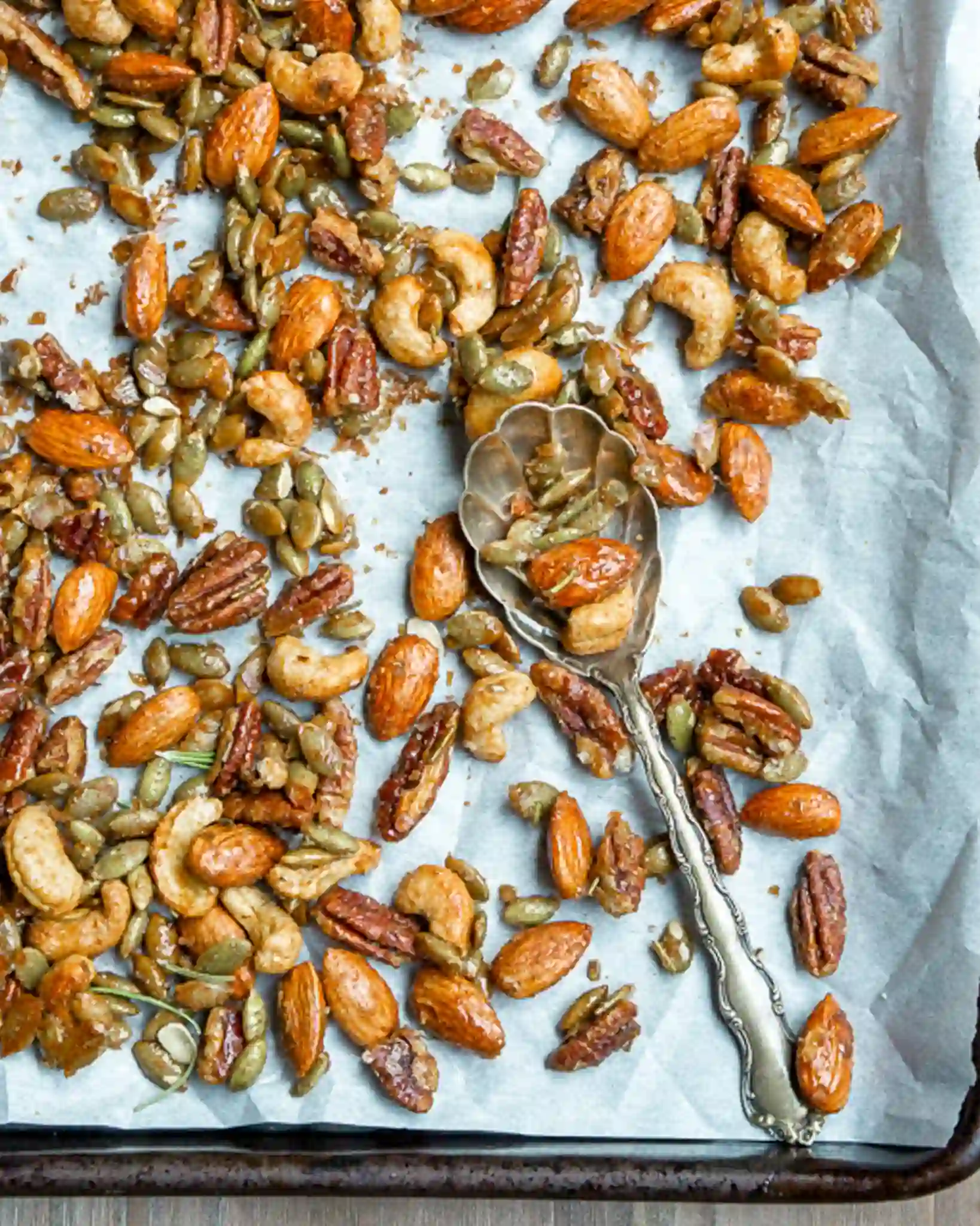 mixed nuts on a tray with a spoon