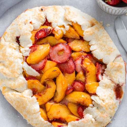 strawberries and peaches in the center of pie crust that's folded over and baked.