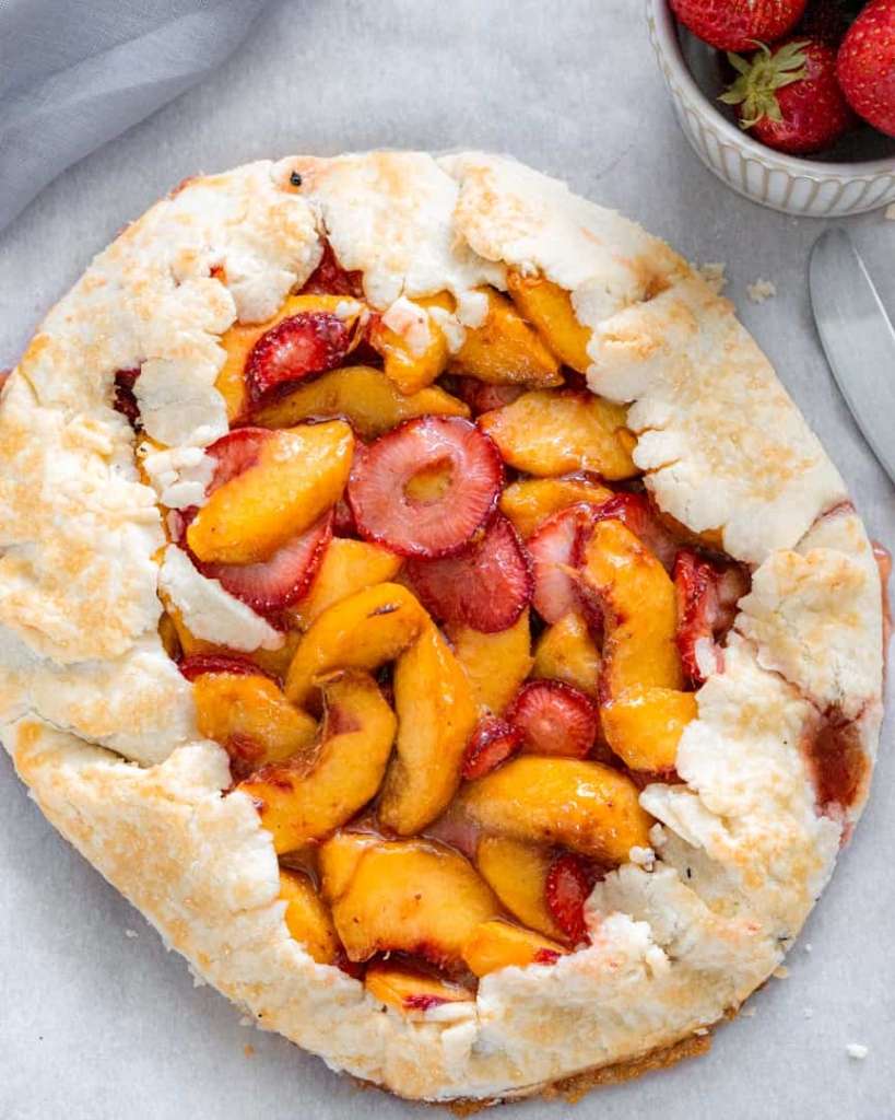 strawberries and peaches in the center of pie crust that's folded over and baked.