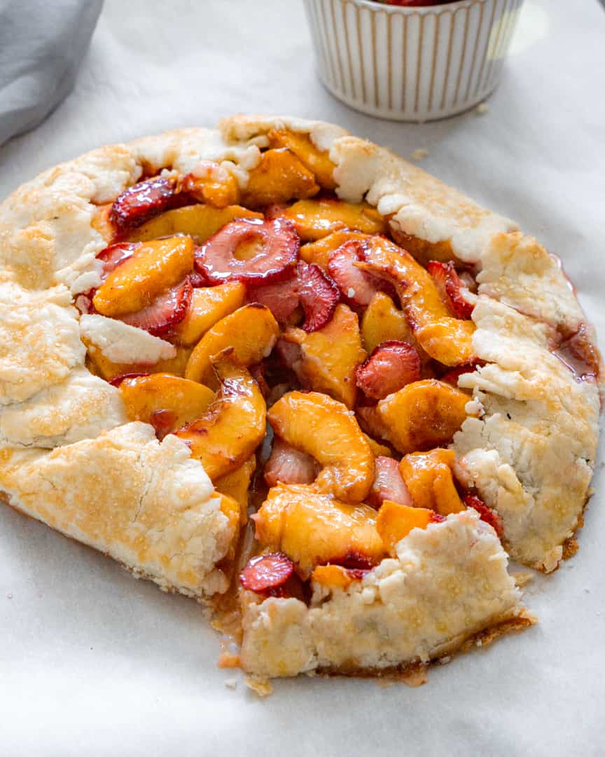 slice of strawberry peach galette pulled away from the rest of the galette
