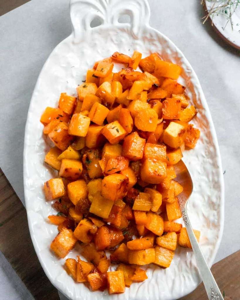 Roasted butternut squash cubes on a plate with a spoon