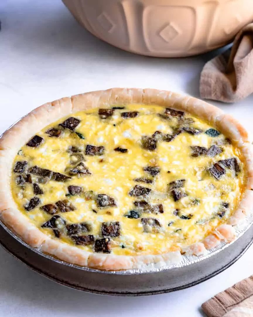 A side view of a zucchini and eggplant quiche.