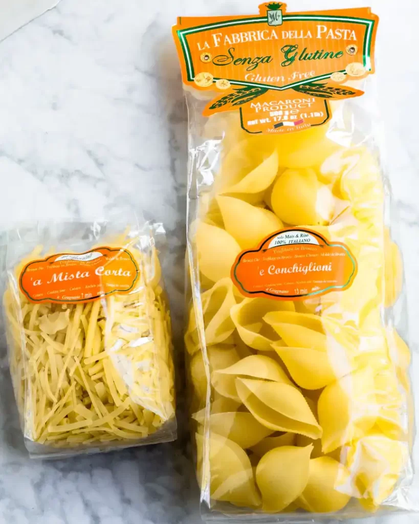 Two bags holding different types of gluten-free pasta shapes