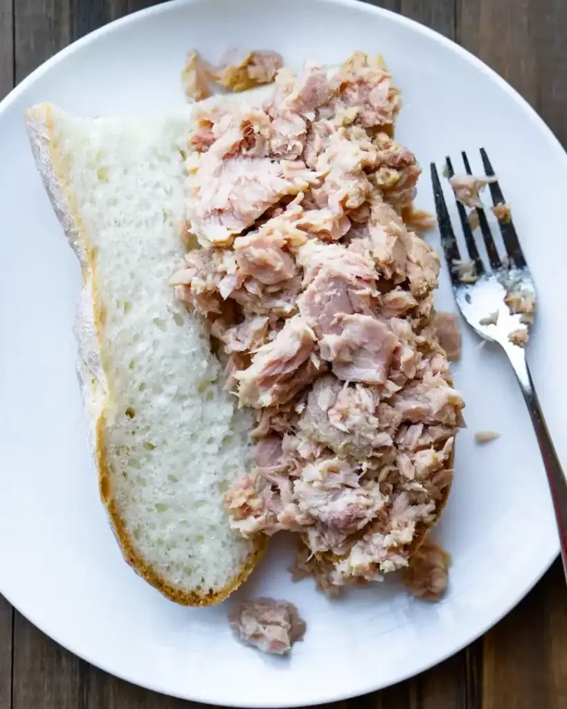 Canned tuna on a opened baguette.