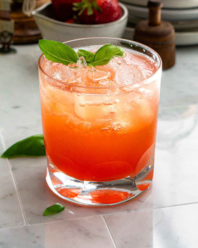 A glass of strawberry basil spritzer