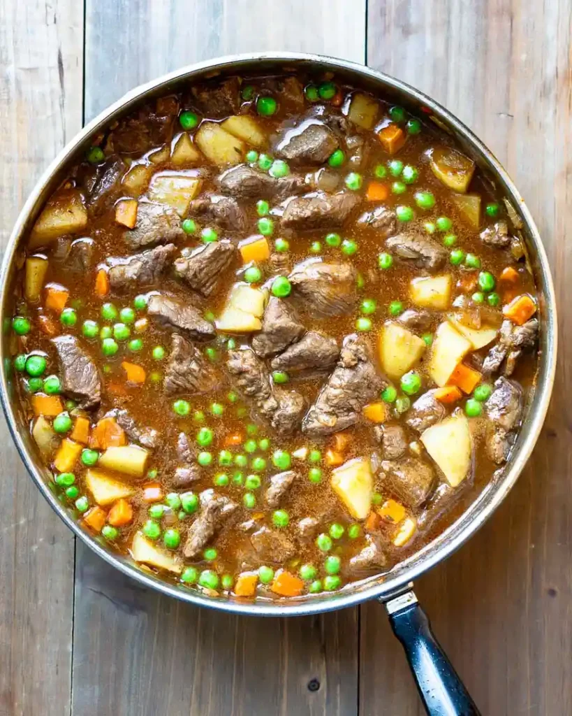 Beef pot pie filling in a stockpot.