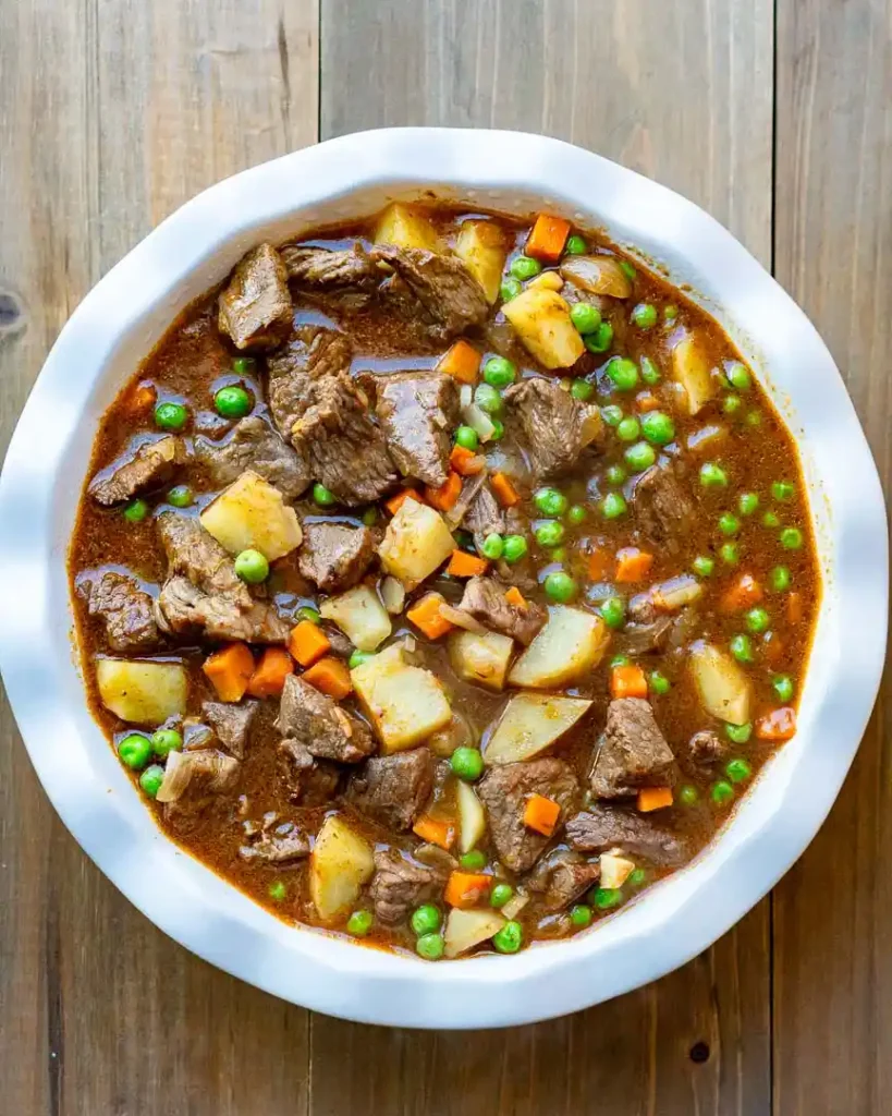 A pie dish filled with beef pot pie filling.