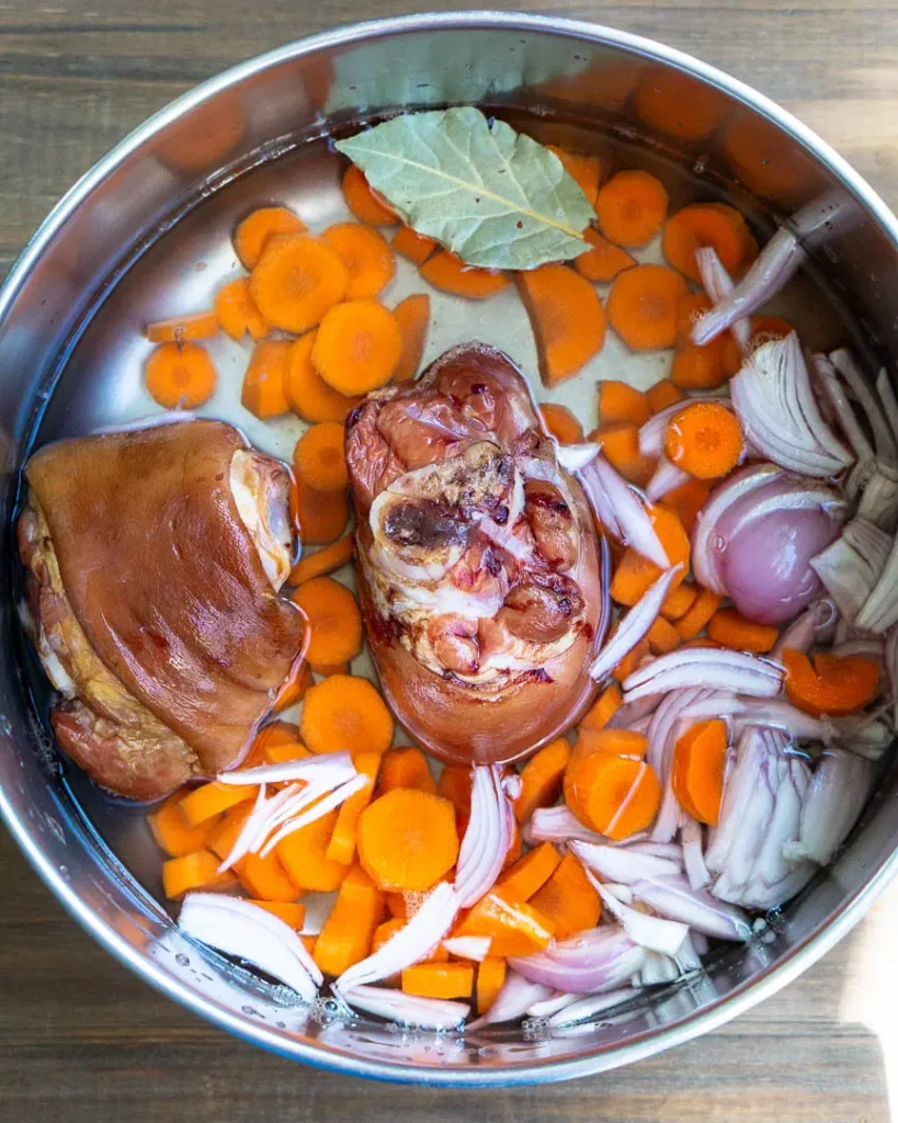 Soup ingredients in a stock pock with water.