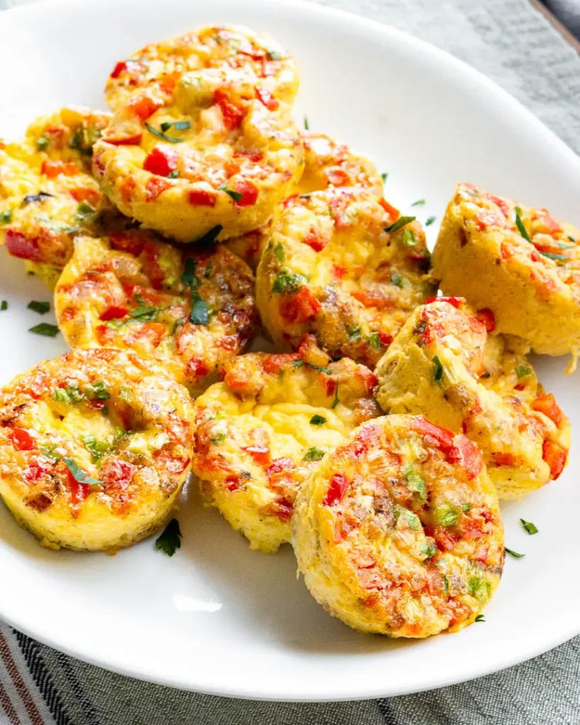A plate of savory egg bites with pancetta piled onto each other.