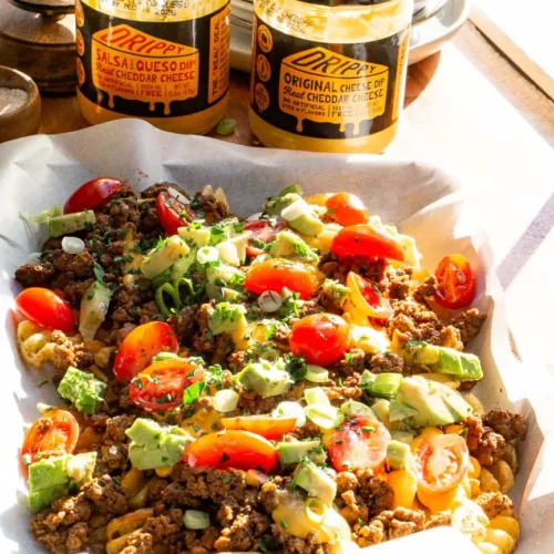 A tray of loaded waffle fries with toppings.