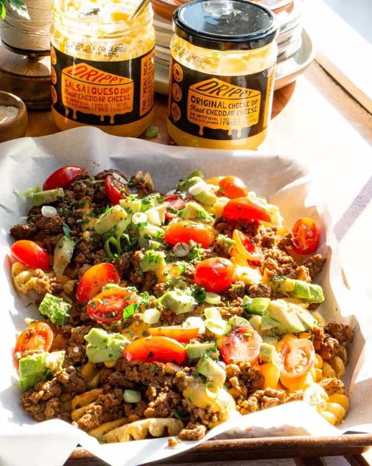 A tray of loaded waffle fries with toppings.
