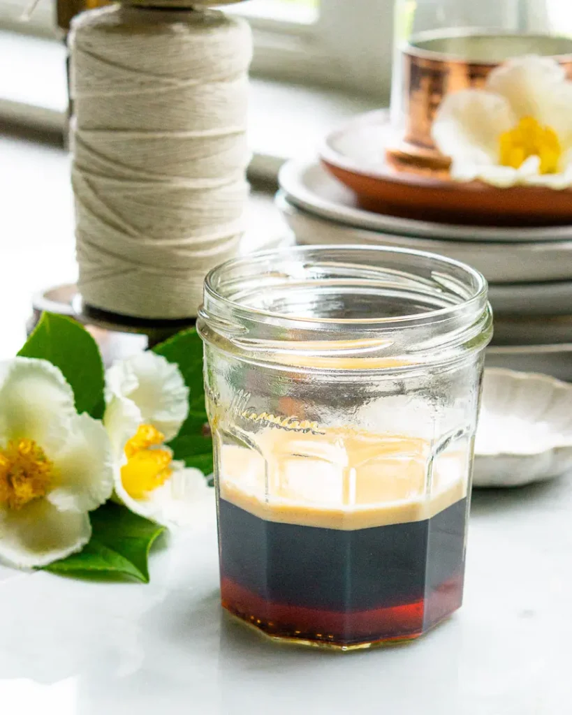 A jam jar filled with a double shot of espresso, honey and sea salt.