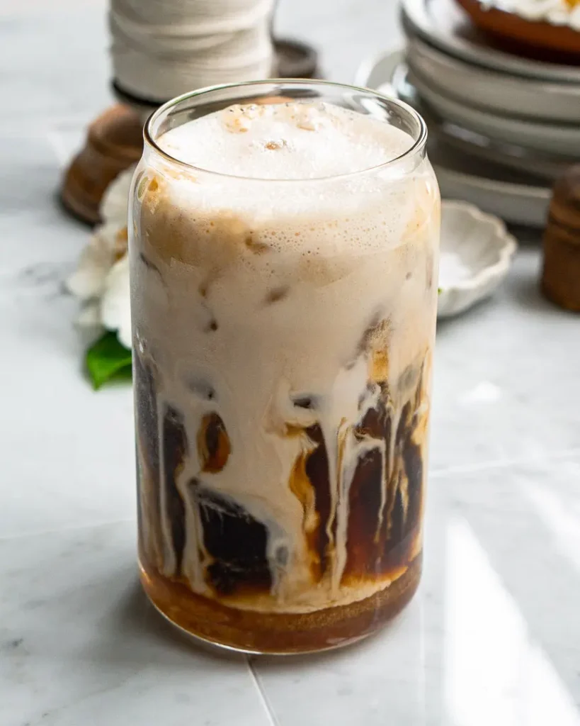 Salted Honey Iced Latte with milk and cold foam swirls showing before being mixed.