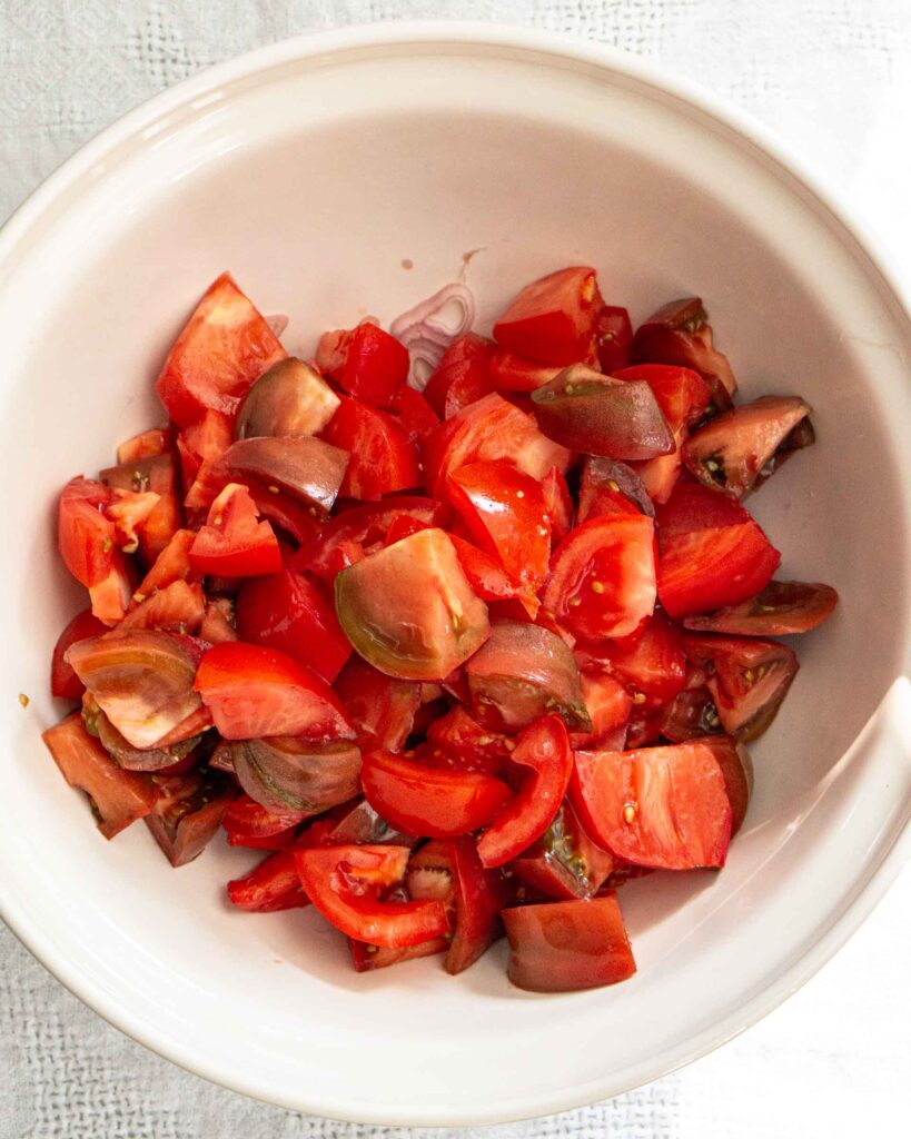Large chunks of tomatoes in a bowl.