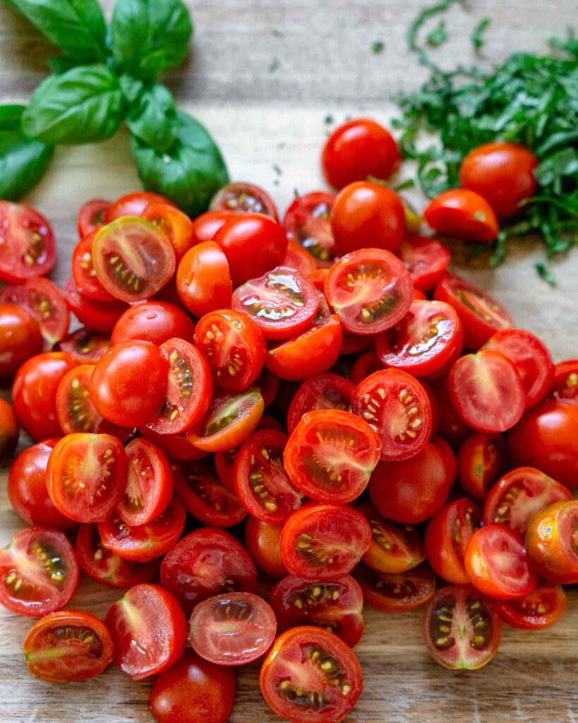 Cherry tomatoes cut in half and piled onto each other.
