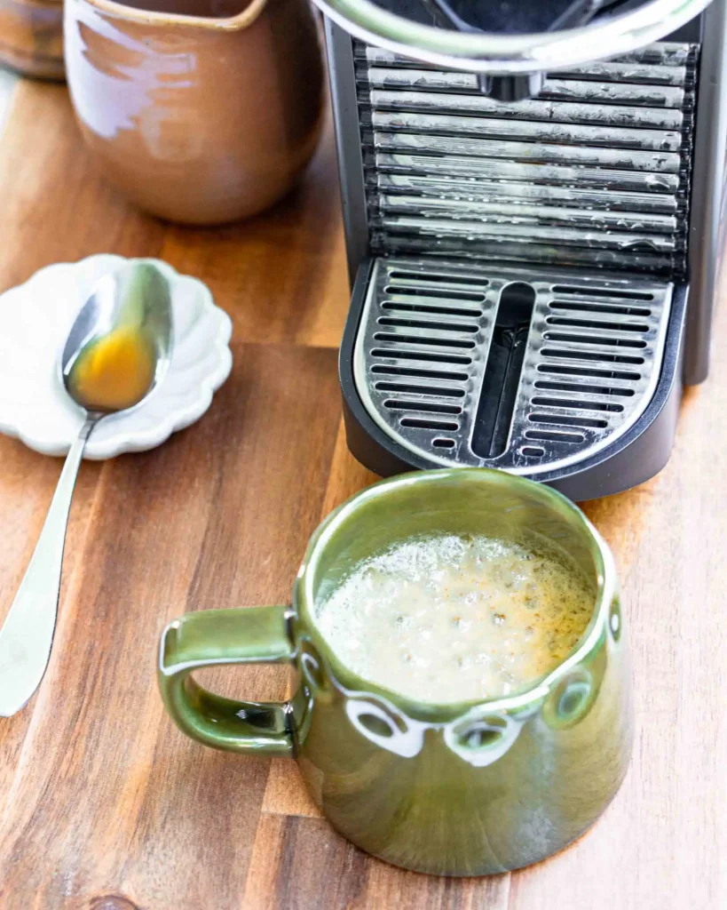 A mug with a double shot of espresso in it.