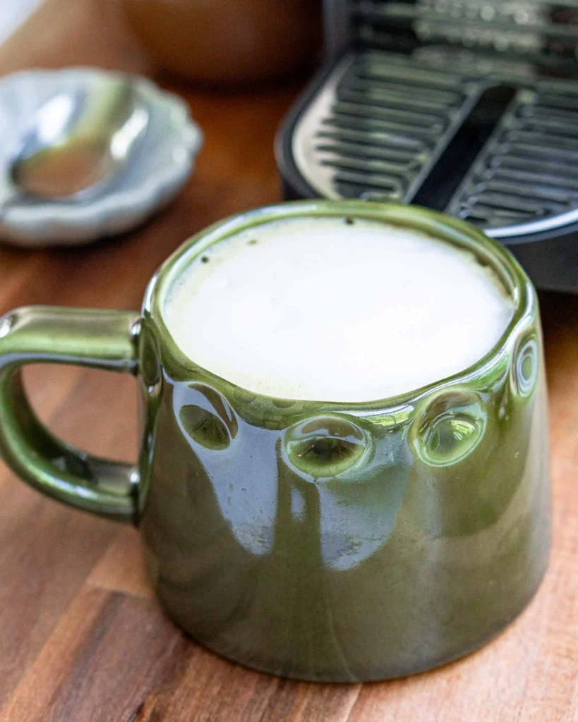 A salted honey latte with frothed honey milk poured over it.